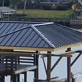 Standing seam metal roof installed on a waterfront structure