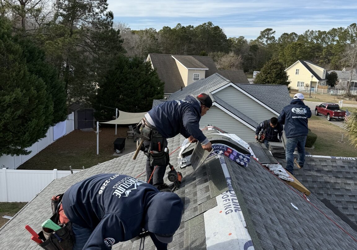 Coastline Roofing crew installing asphalt shingles during a roof replacement